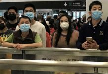 ONU: Gente con mascarillas para protegerse del coronavirus espera en la zona de llegadas del aeropuerto internacional de Shenzhen Bao’an.