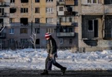 Un niño pasa frente a un edificio dañado en el este de Ucrania, donde están las regiones separatistas cuya protección invocó Rusia para la operación militar en gran escala que lanzó el jueves 24 sobre el país vecino. © Ashley Gilbertson/Unicef