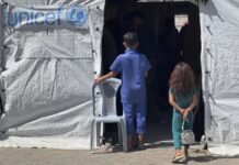 Las fusiones de agencias de la ONU para reducir costes ponen en peligro objetivos humanitarios Dos niños frente a una tienda de campaña, el 26 de septiembre 2025, utilizada para brindar servicios médicos en el Hospital Al Aqsa de Deir al Balah, en la Franja de Gaza. ©James Elder / Unicef